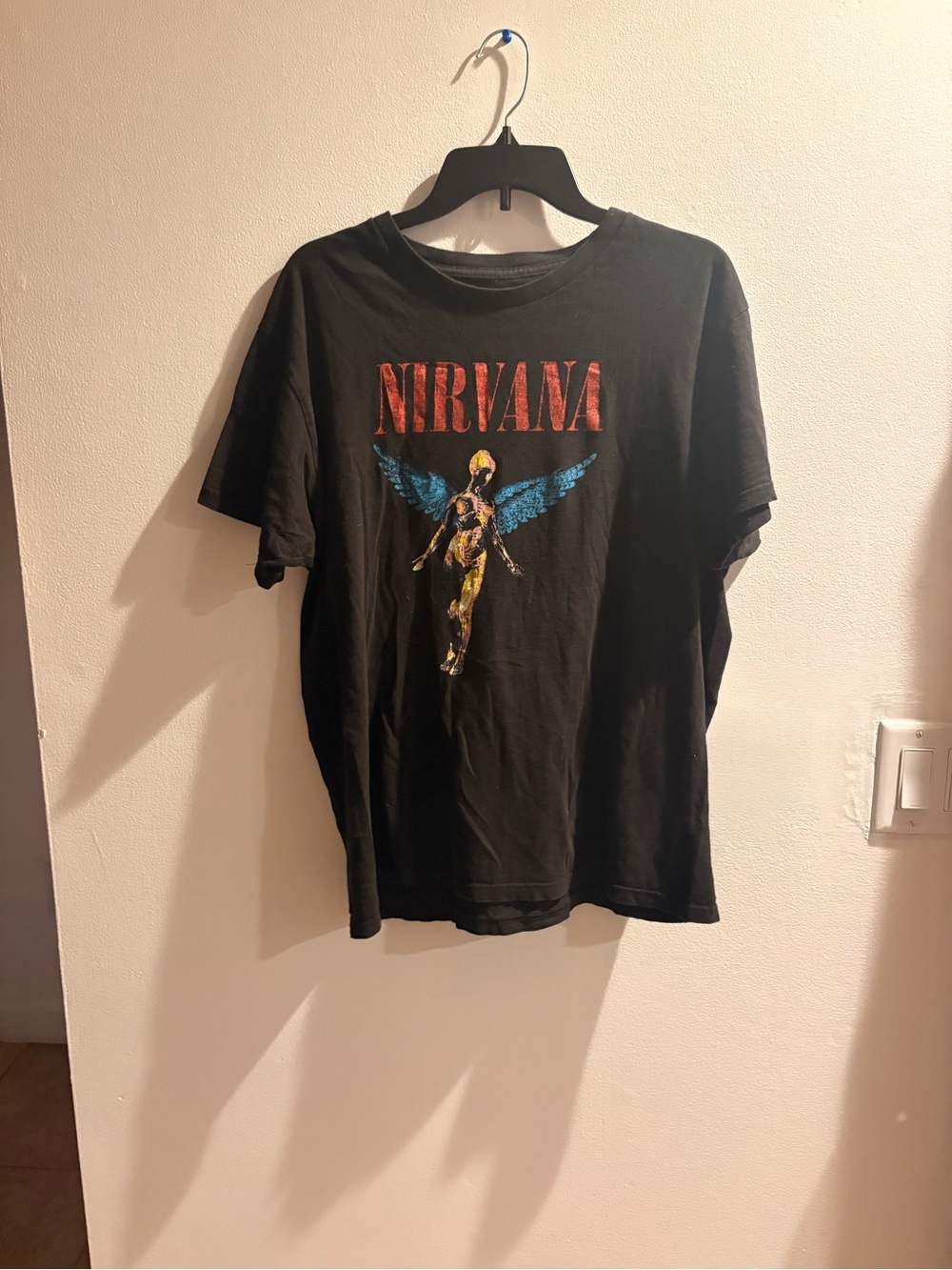 NIRVANA Black Tee with Red Logo and Blue Winged Angel Graphic
